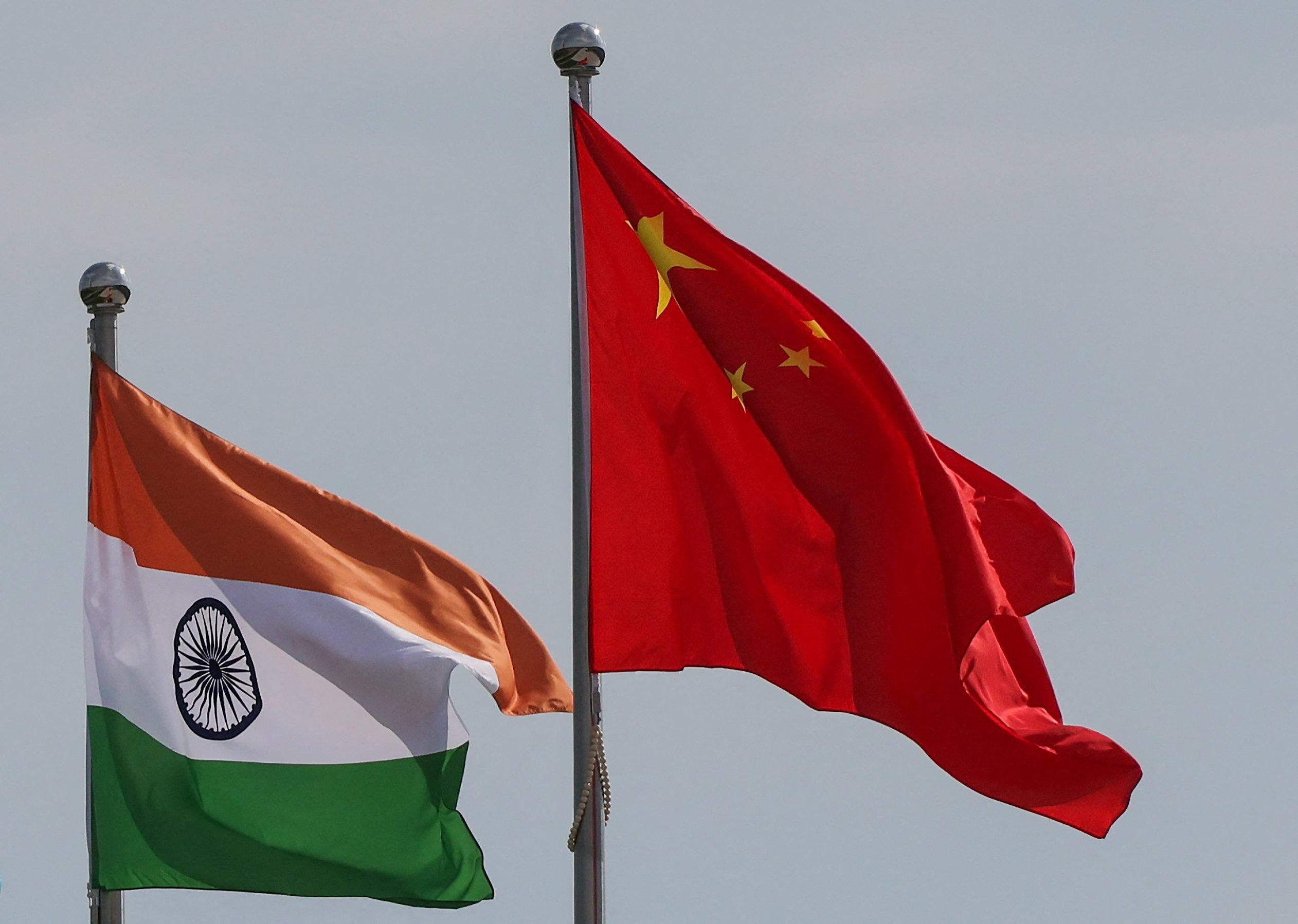 National flags of China and India fly next to the Meijiang Convention and Exhibition Center, a venue for 2025 Shanghai Cooperation Organisation (SCO) summit in Tianjin