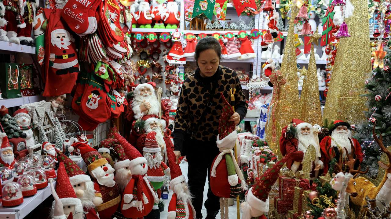 FILE PHOTO: A vendor sorts products at a booth selling Christmas decorations at a mall in Beijing