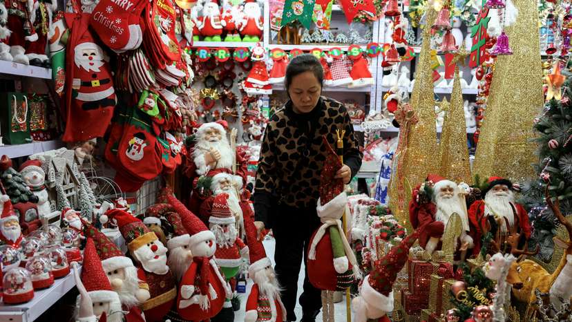 FILE PHOTO: A vendor sorts products at a booth selling Christmas decorations at a mall in Beijing
