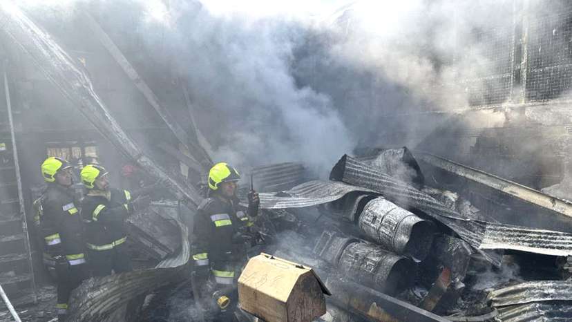 Rescue forces work at the site of an Iranian army helicopter crash in a fruit market in Isfahan
