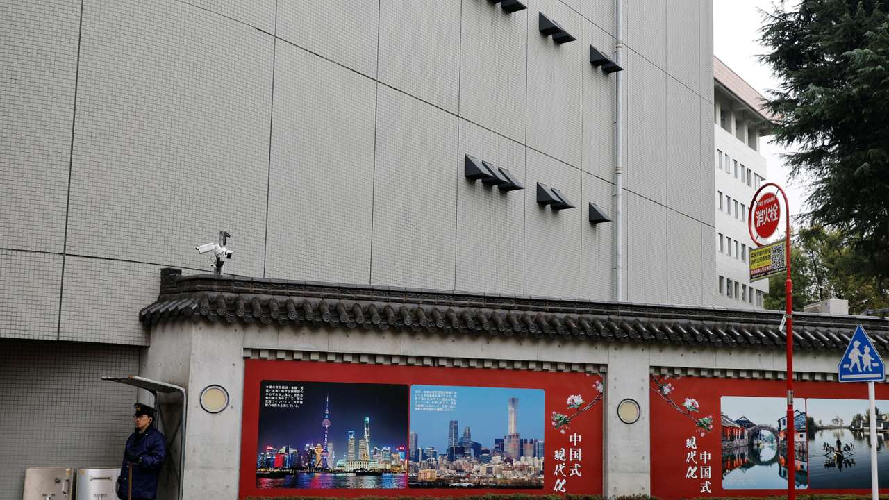 A Japanese police officer stands guard in front of the Chinese Embassy in Tokyo