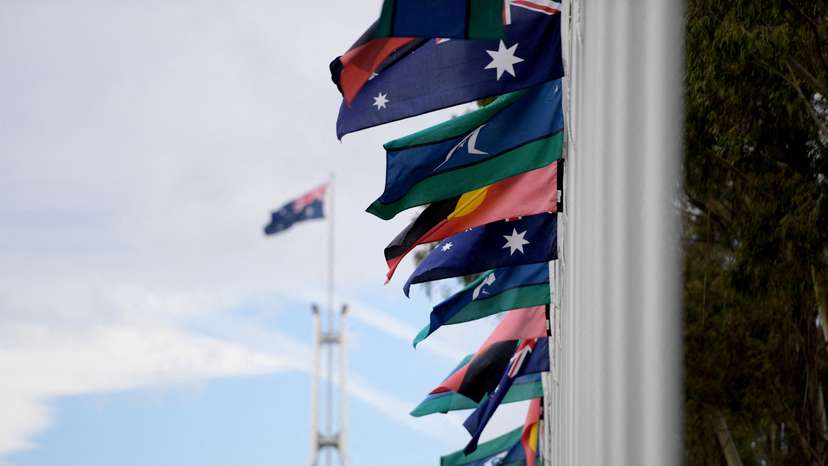 FILE PHOTO: Australian Aboriginal and Torres Strait Islander flags are pictured in front of Parliament House