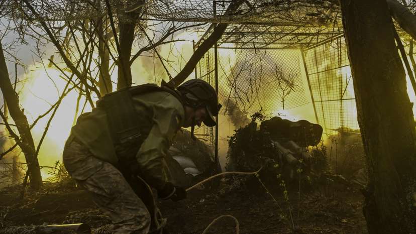 Ukrainian servicemen fire a field artillery gun towards Russian troops at a frontline position in Zaporizhzhia region