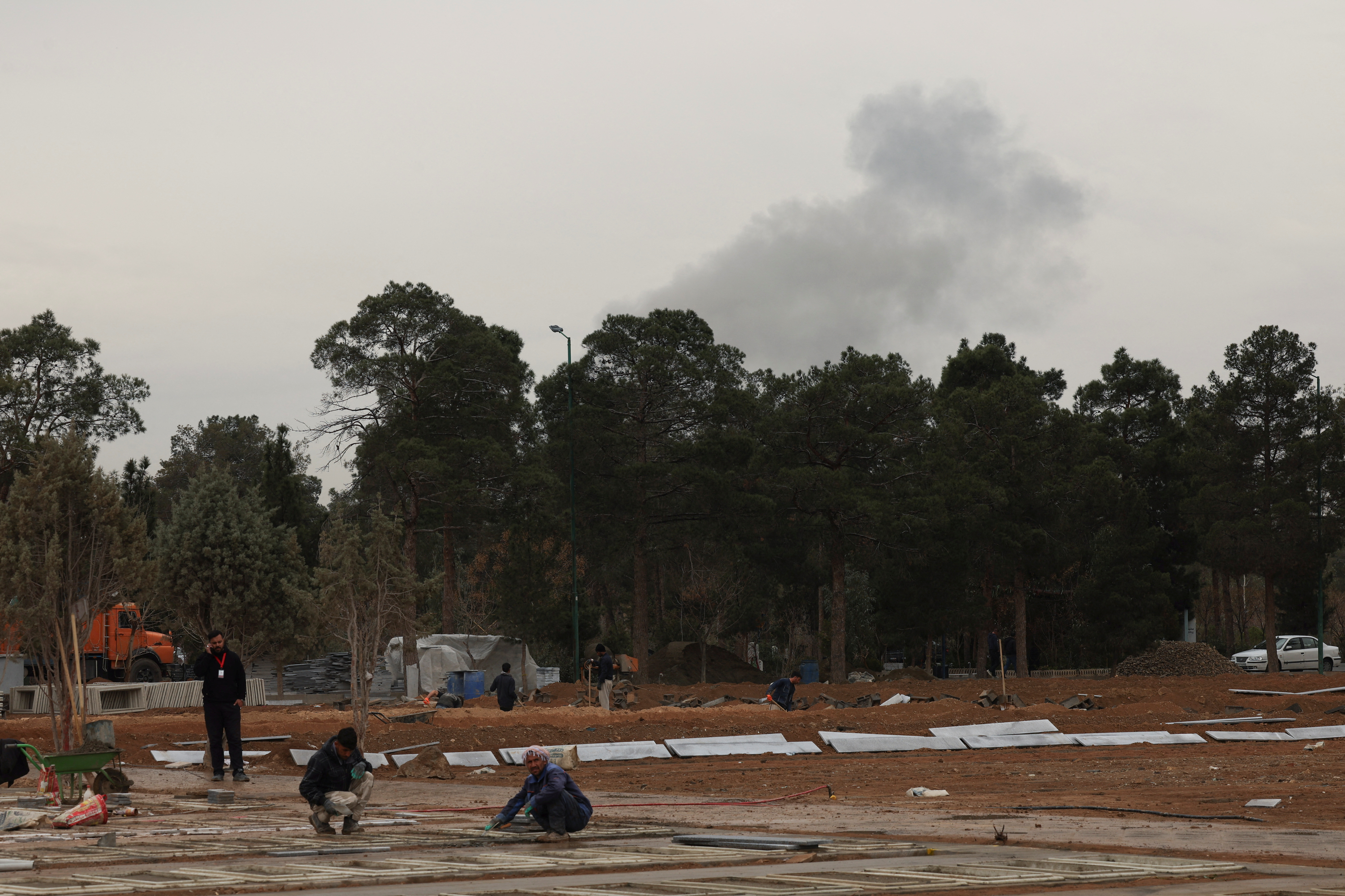 People work during an expansion of a cemetery in Behesht-e Zahra, amid the U.S.-Israeli conflict with Iran