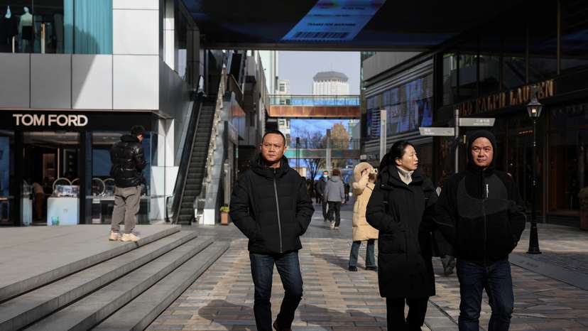 People walk at a shopping compound in Beijing