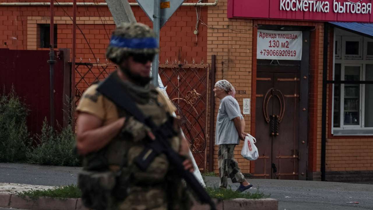 FILE PHOTO: A Ukrainian serviceman patrols in the town of Sudzha