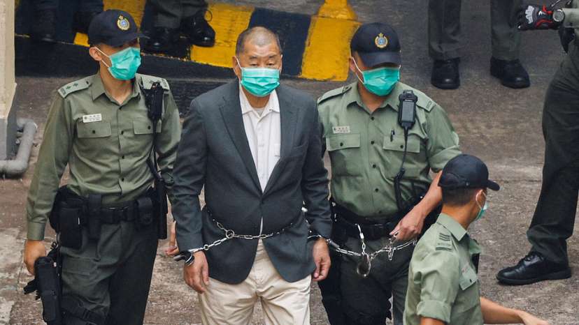 FILE PHOTO: Media mogul Jimmy Lai Chee-ying, founder of Apple Daily, walks to a prison van to head to court, after being charged under the national security law, in Hong Kong