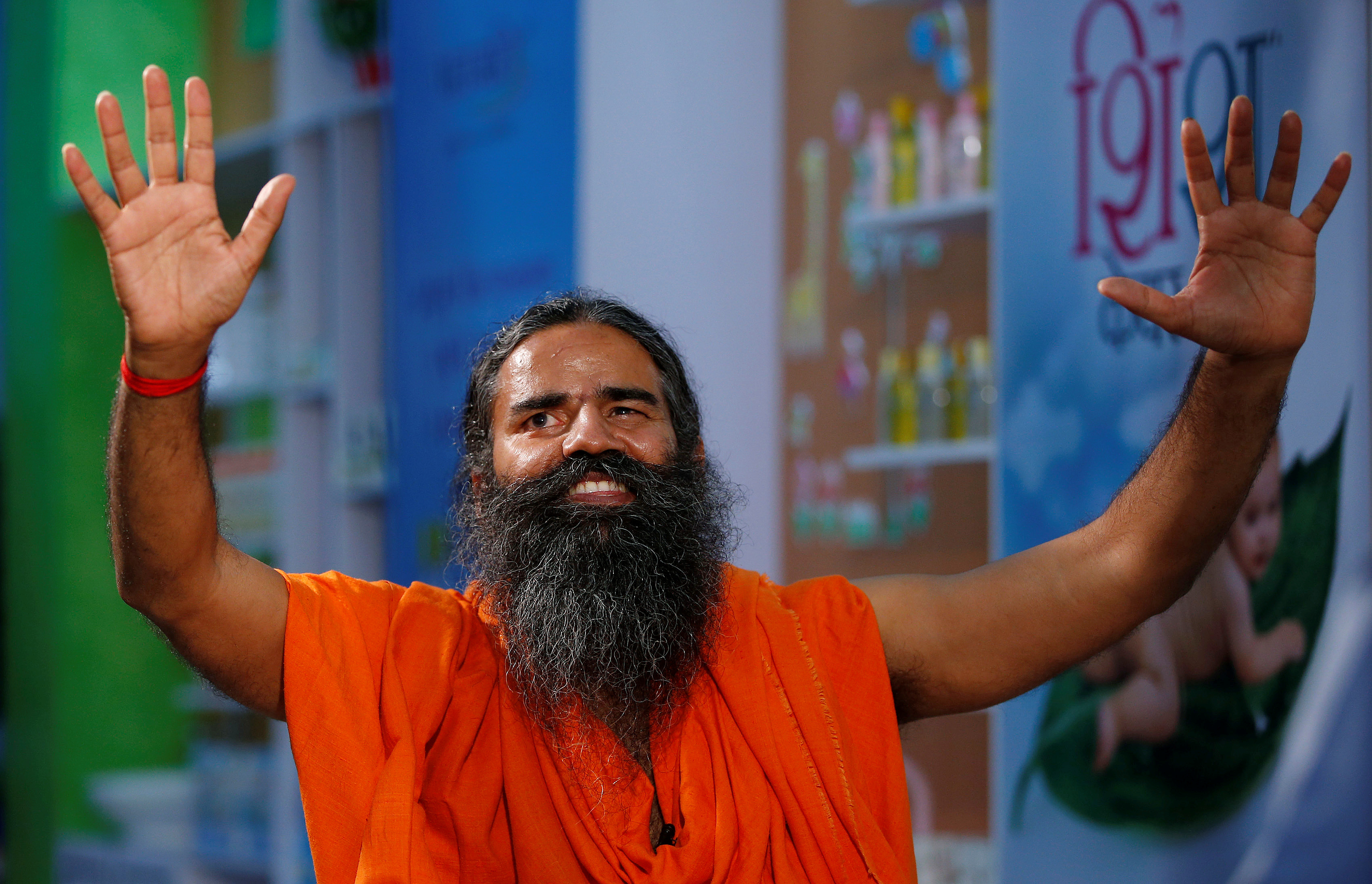 Indian yoga guru Baba Ramdev gestures as talks to media after a news conference in New Delhi