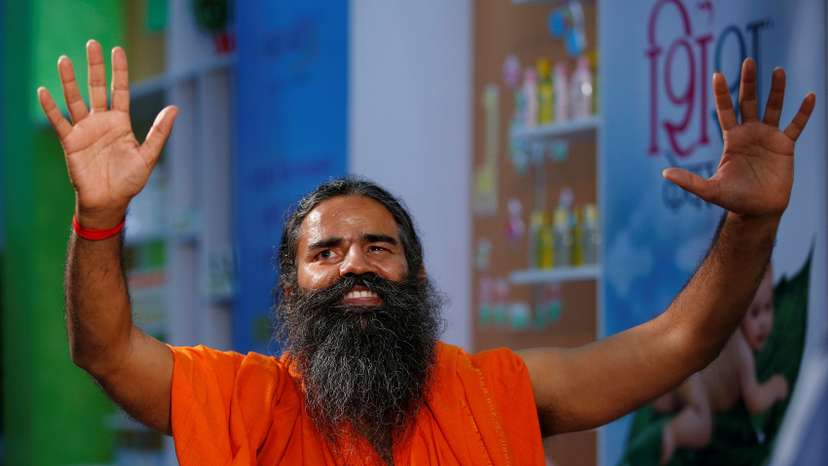 Indian yoga guru Baba Ramdev gestures as talks to media after a news conference in New Delhi