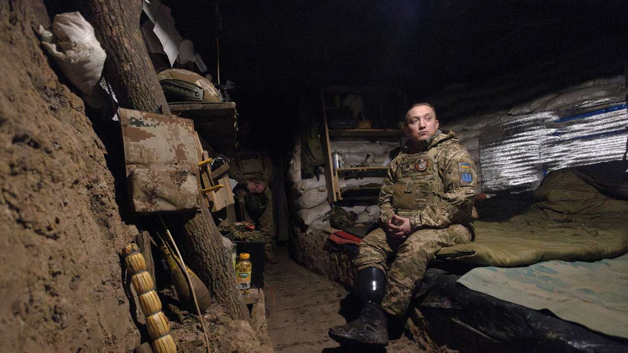 Odin, a commander in the 28th Separate Mechanized Brigade who lost his lower leg stands in a dugout, in Donetsk
