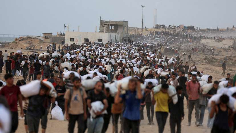 FILE PHOTO: Palestinians receive aid supplies in Beit Lahia