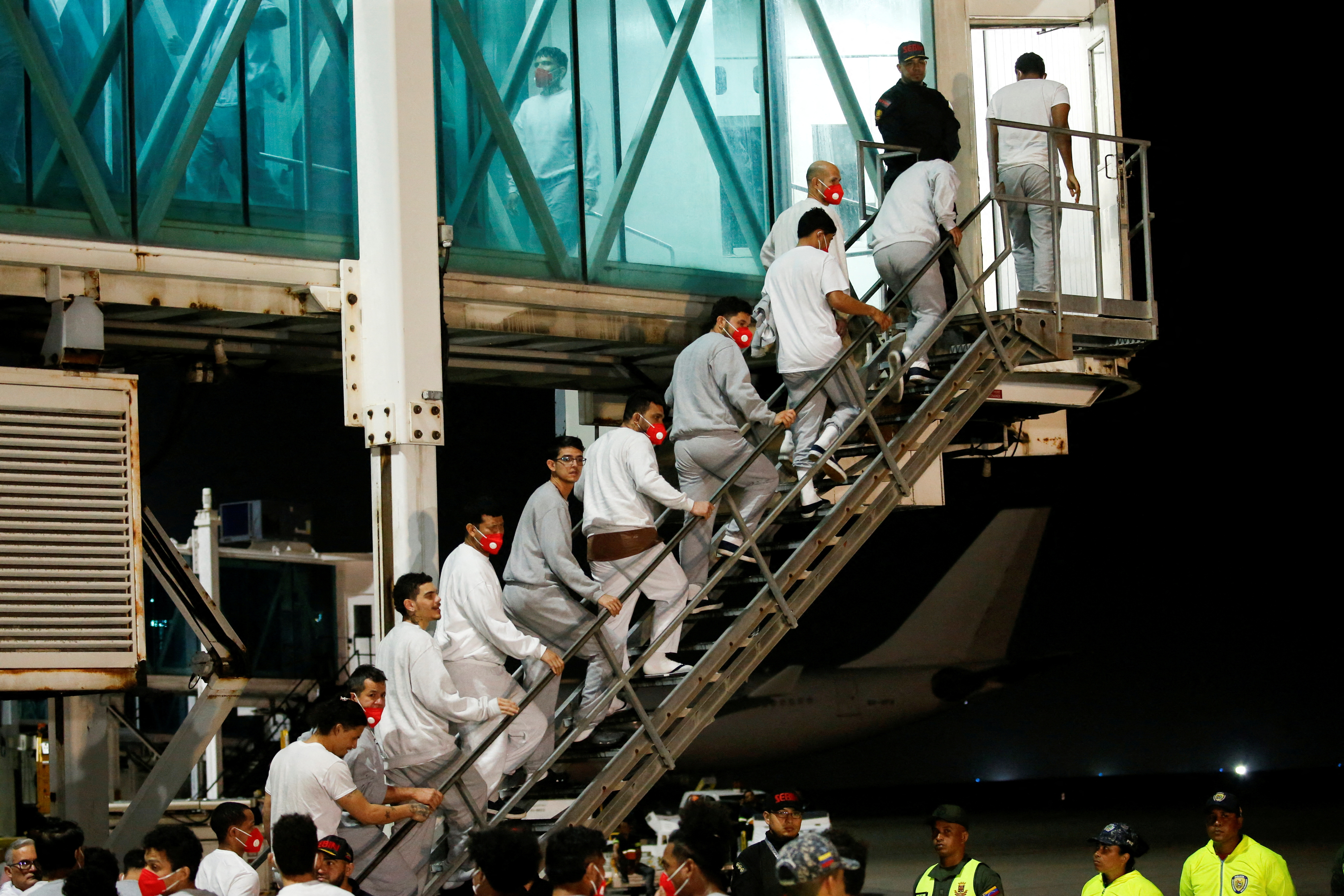 FILE PHOTO: Venezuelan migrants flown home from Guantanamo Bay via Honduras, arrive on a deportation flight at Simon Bolivar International Airport in Maiquetia