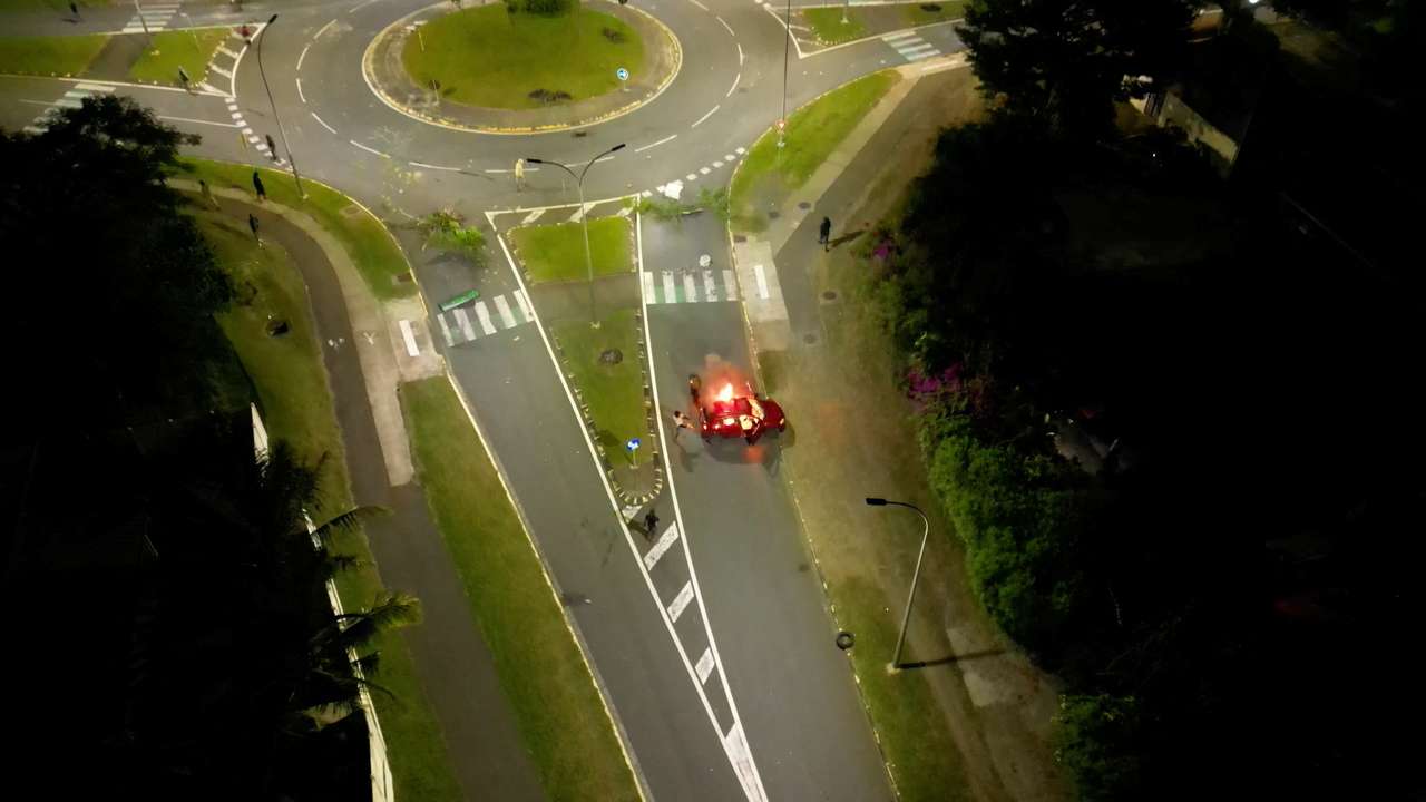 A car is set on fire amid protests in Noumea