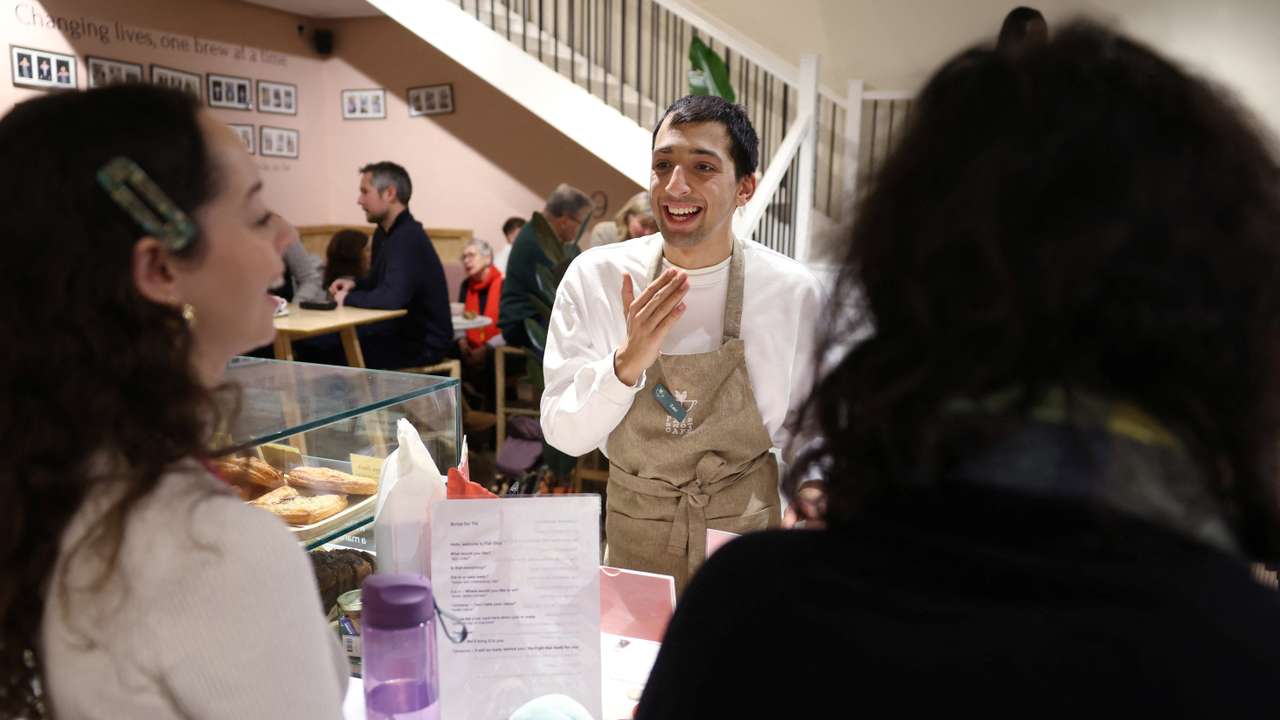 Zaki (centre) gets advice from skills coach Natalia as they work in Fair Shot