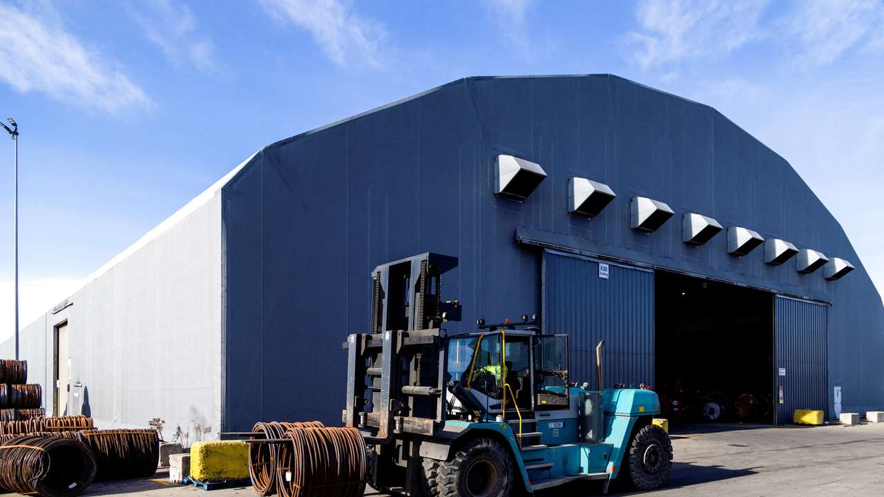 FILE PHOTO: A worker operates a forklift to move coiled steel outside a warehouse at Ontario Shipyards in Hamilton