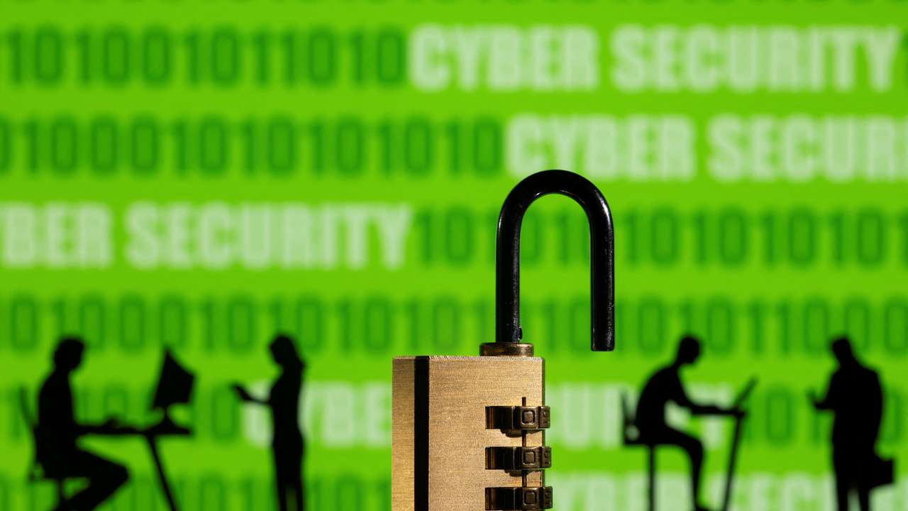 Illustration shows displayed CYBER SECURITY words and binary code