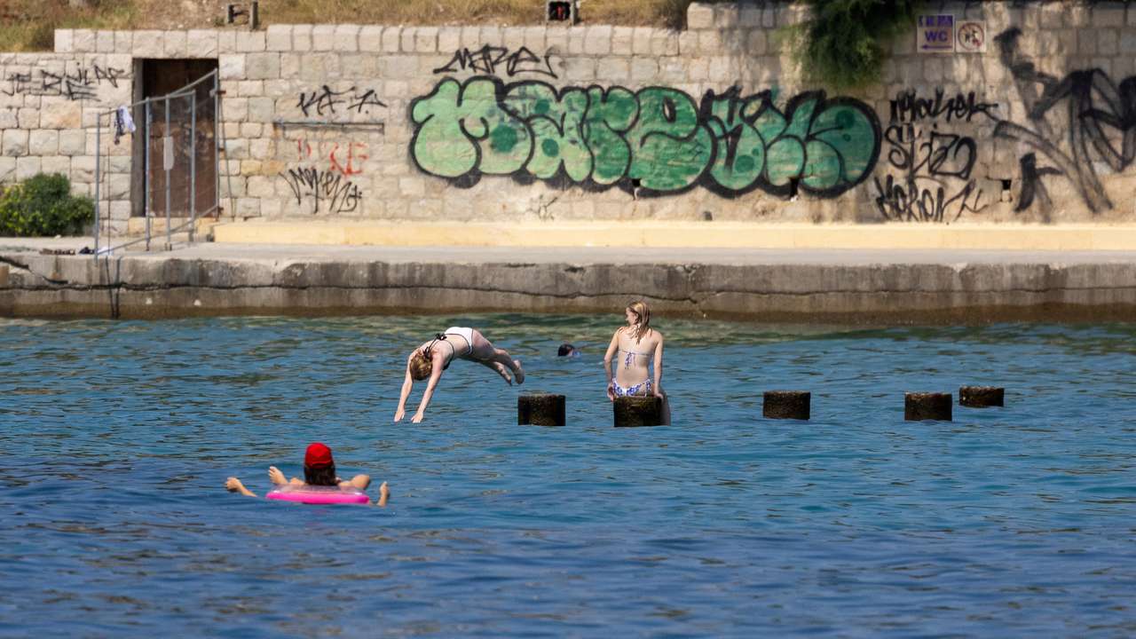 A girl plunges into the Adriatic Sea in Split