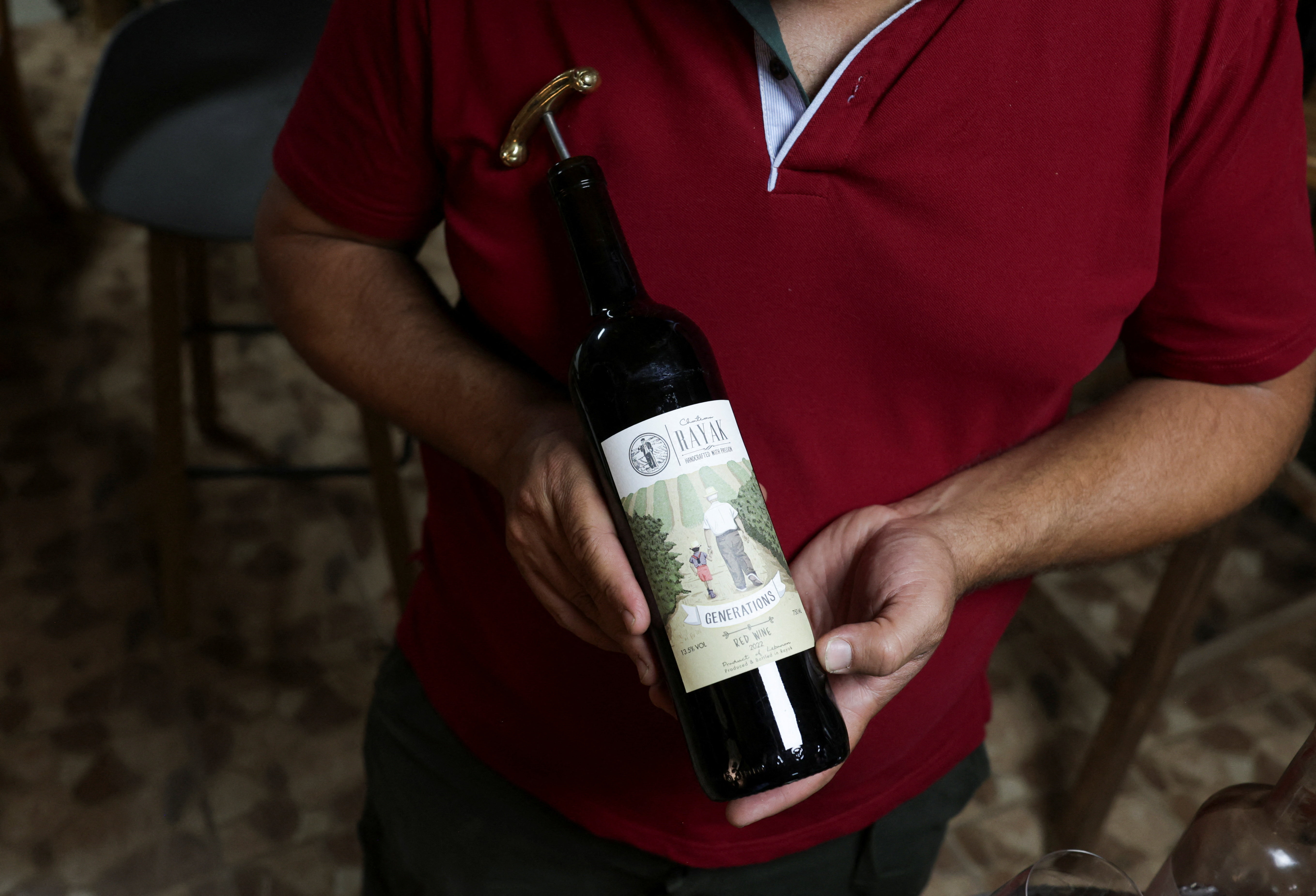 Elias Maalouf, Lebanese winemaker, holds a Rayak wine bottle in Riyak, Bekaa valley