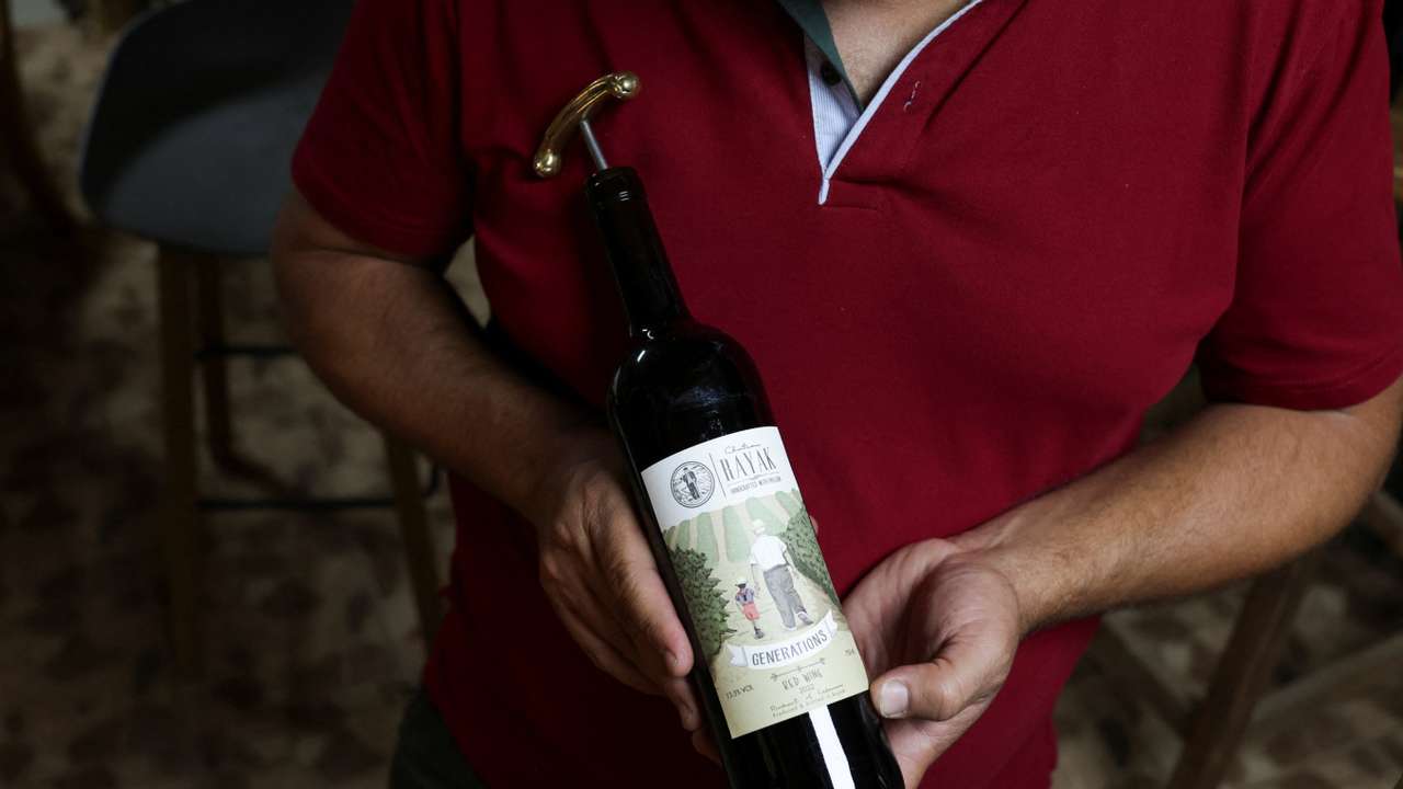 Elias Maalouf, Lebanese winemaker, holds a Rayak wine bottle in Riyak, Bekaa valley