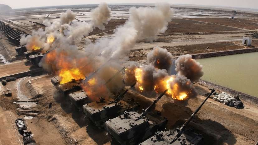 North Korean leader Kim Jong Un guides an artillery firing drill by the Korean People's Army