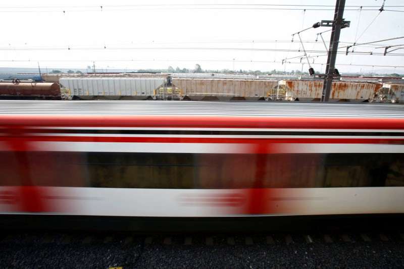 FILE PHOTO: A suburban train is passing next to a freight train in the Tlalnepantla de Baz borough of Mexico City