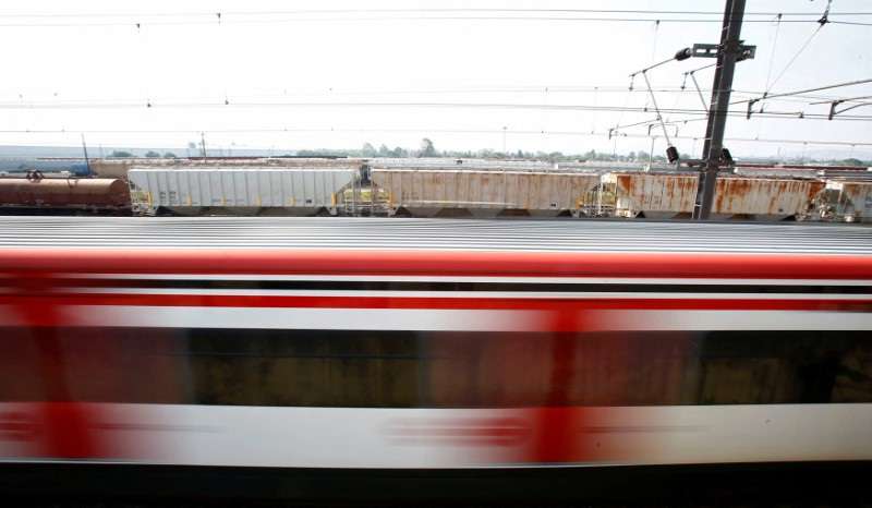 FILE PHOTO: A suburban train is passing next to a freight train in the Tlalnepantla de Baz borough of Mexico City