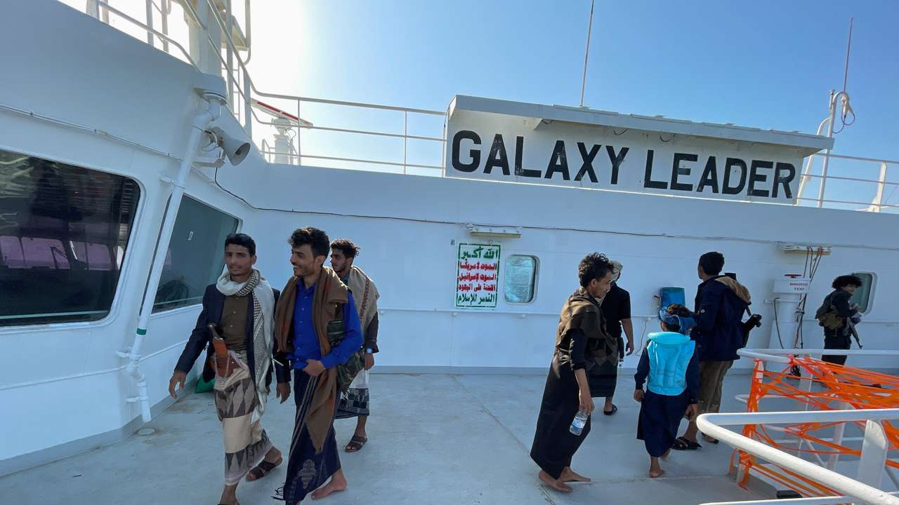 People tour the deck of the Galaxy Leader commercial ship, seized by Yemen's Houthis last month, off the coast of al-Salif