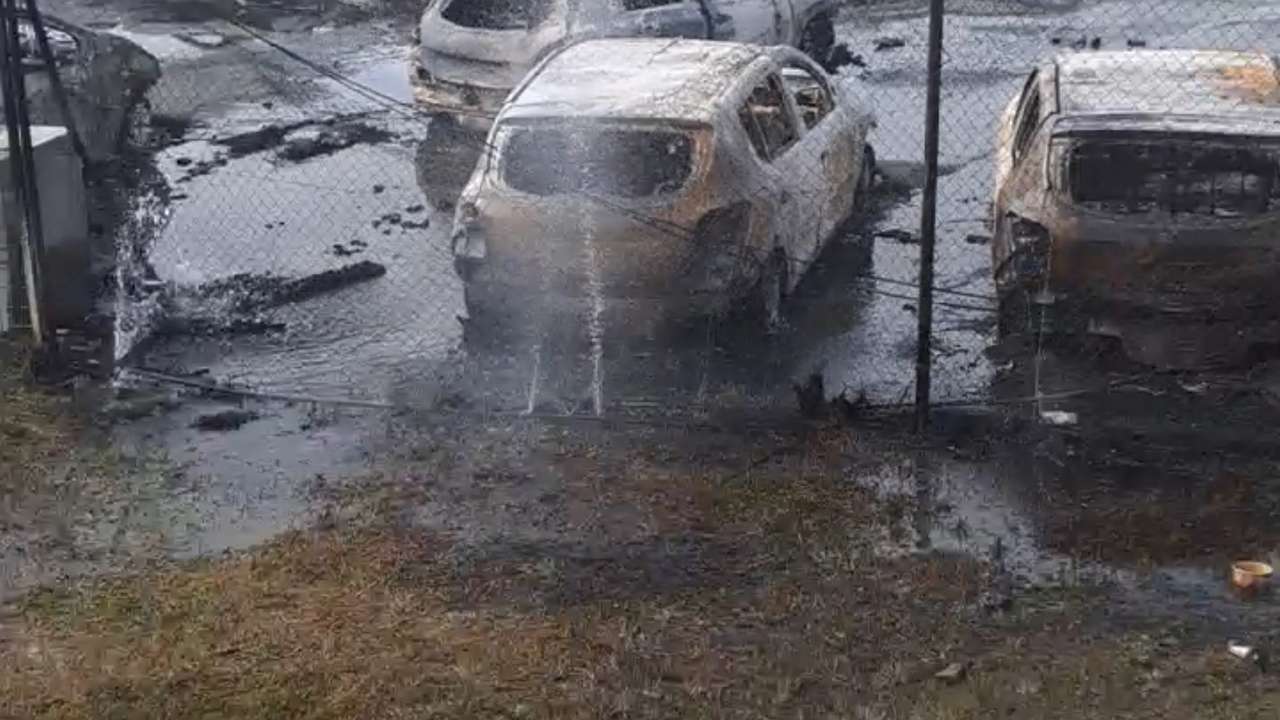 Burnt cars in the aftermath of protests that turned violent, in Noumea