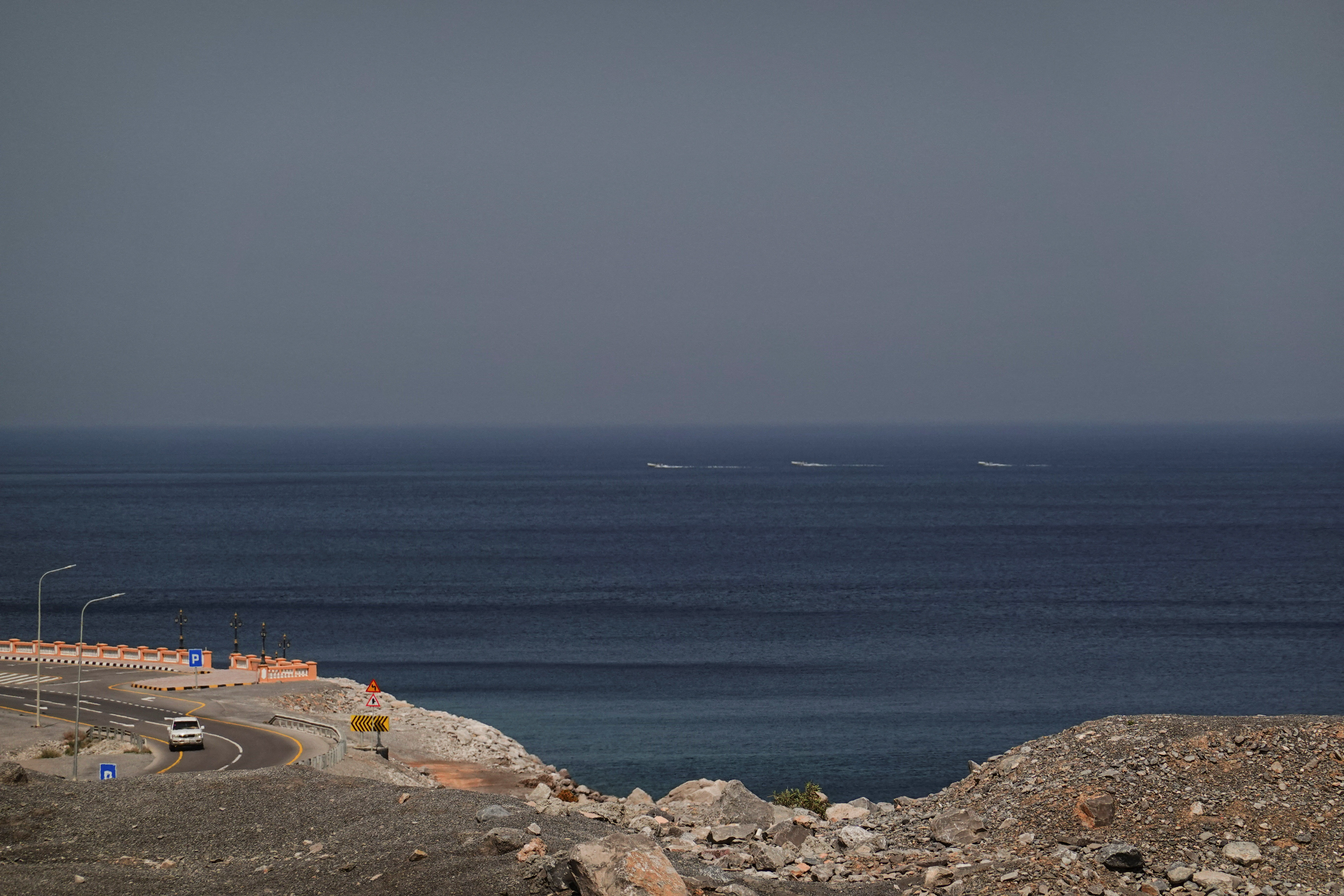 A car rides along the coast of Musandam overlooking the Strait of Hormuz amid the U.S.-Israeli conflict with Iran