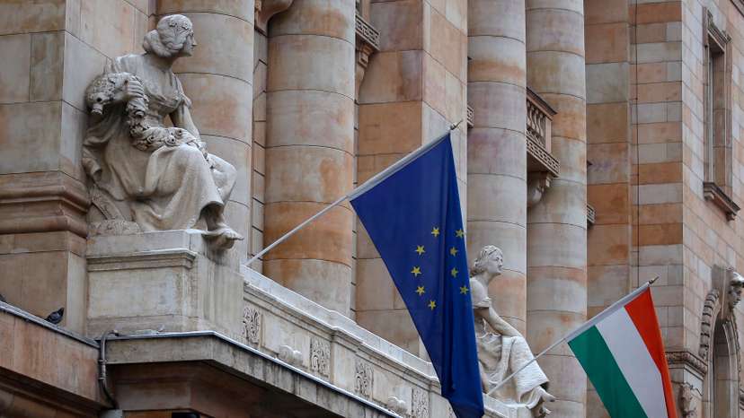 The Hungarian national flag and the flag of the European Union fly on the building of the National Bank of Hungary in Budapest