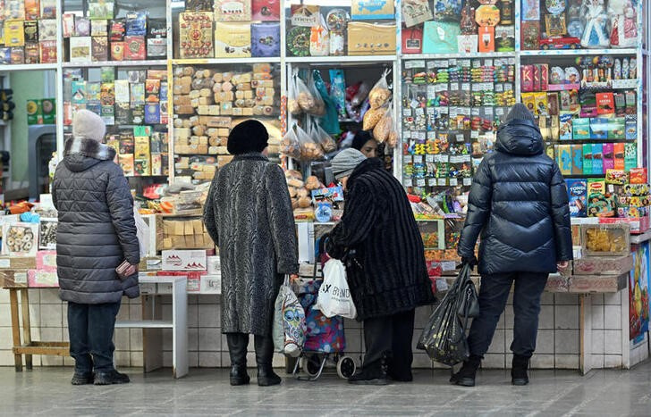FILE PHOTO: Customers buy foodstuffs at a market in Omsk