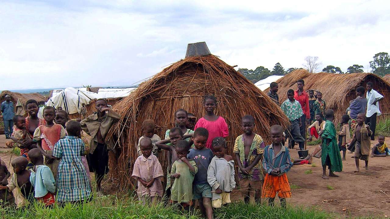 FILE PHOTO: Congolese children in Mitwaba camp for internally displaced people watch as a UN helicopter lifts off in Katanga