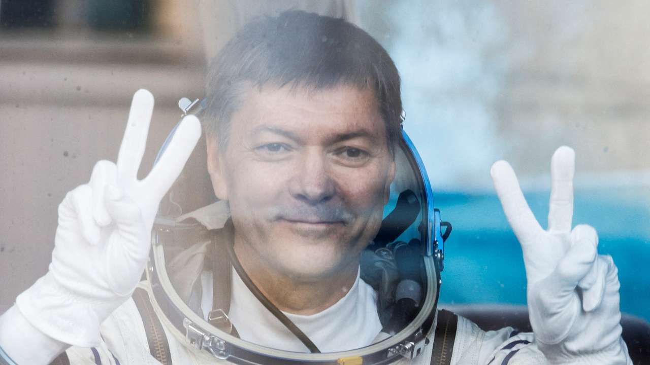 FILE PHOTO: Roscosmos cosmonaut Kononenko reacts in the bus just before the departure to the launchpad at the Baikonur Cosmodrome