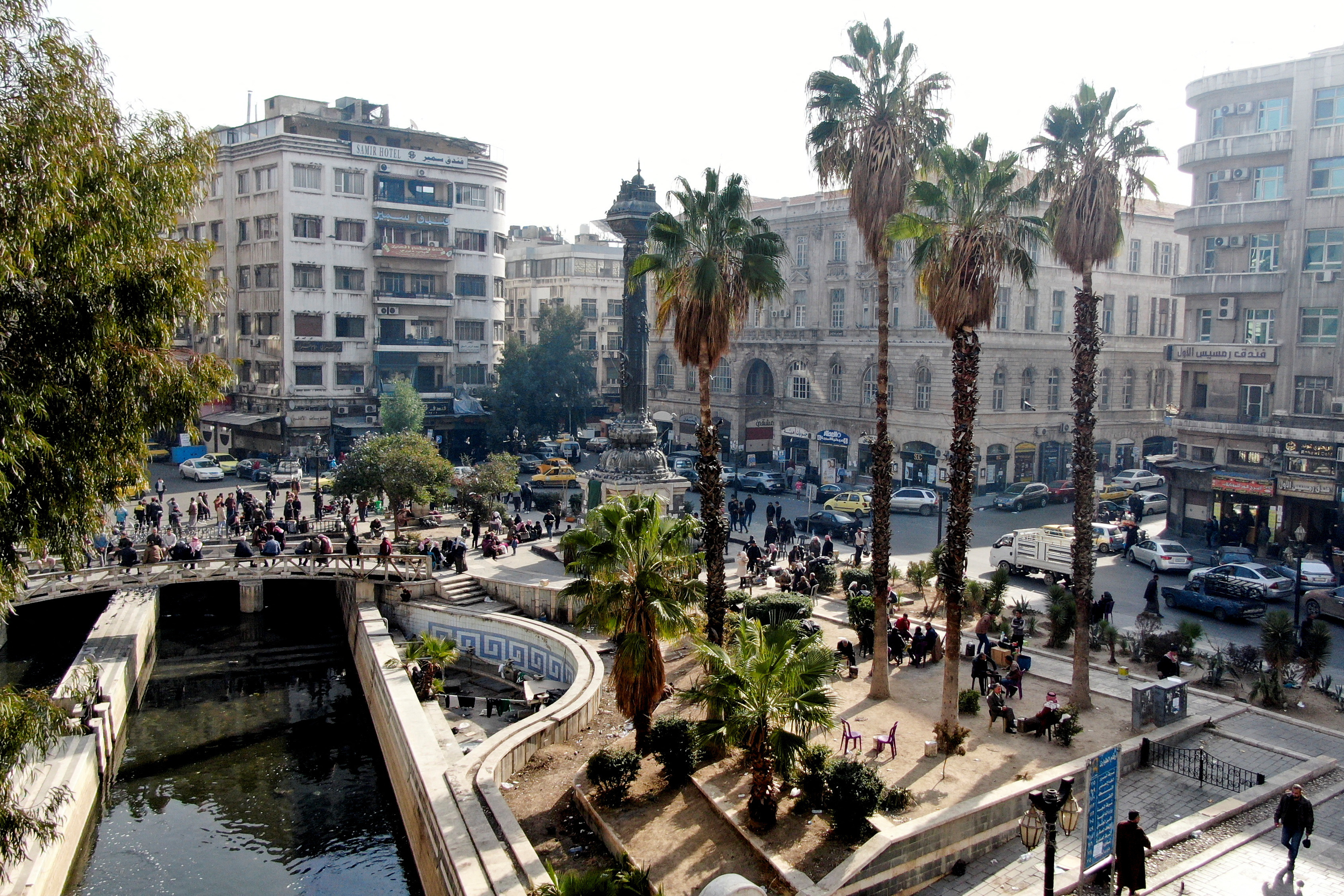 A drone view shows people walking in Damascus