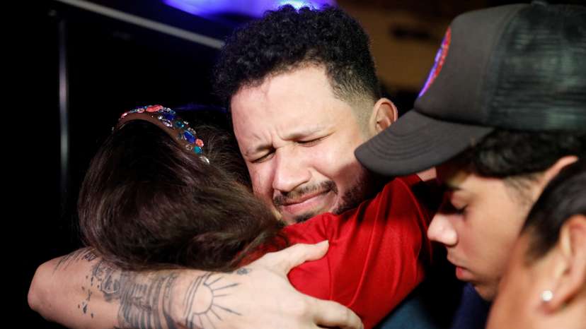 Arturo Suarez, who was held for months in an El Salvador prison, greets family members after his release, in Caracas