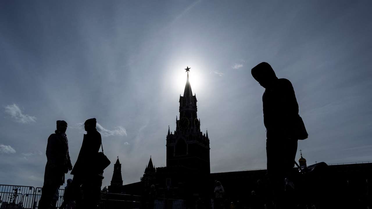 People walk in Red Square on a sunny autumn day in Moscow