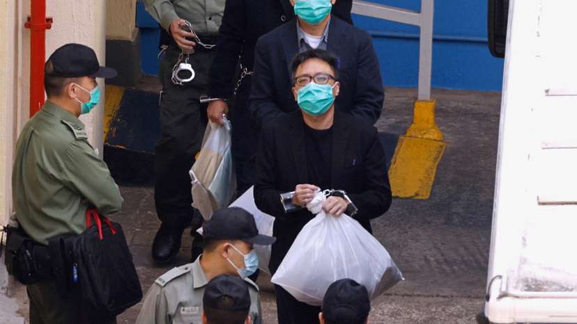Pro-democracy activist Tam Tak-chi walks to a prison van to head to court, over national security law charges, in Hong Kong