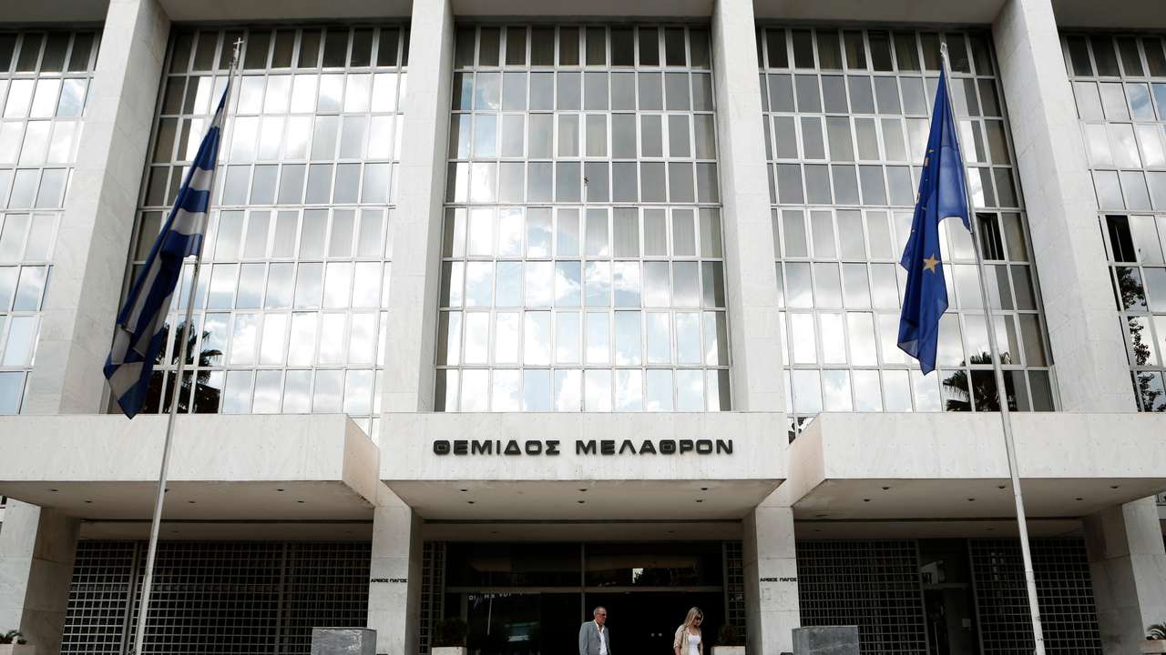 People walk outside Greece's Supreme Court in Athens