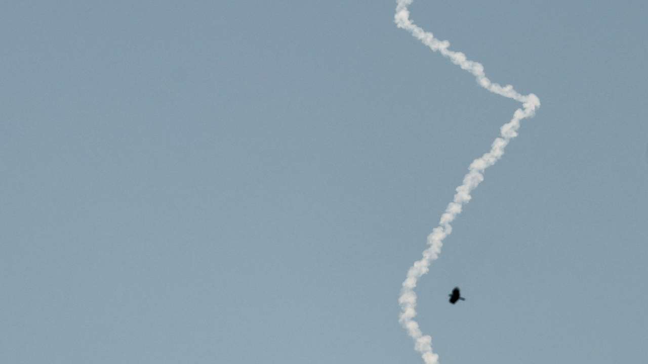 An interceptor missile leaves a smoke trail as seen from Tubas, in the Israeli-occupied West Bank
