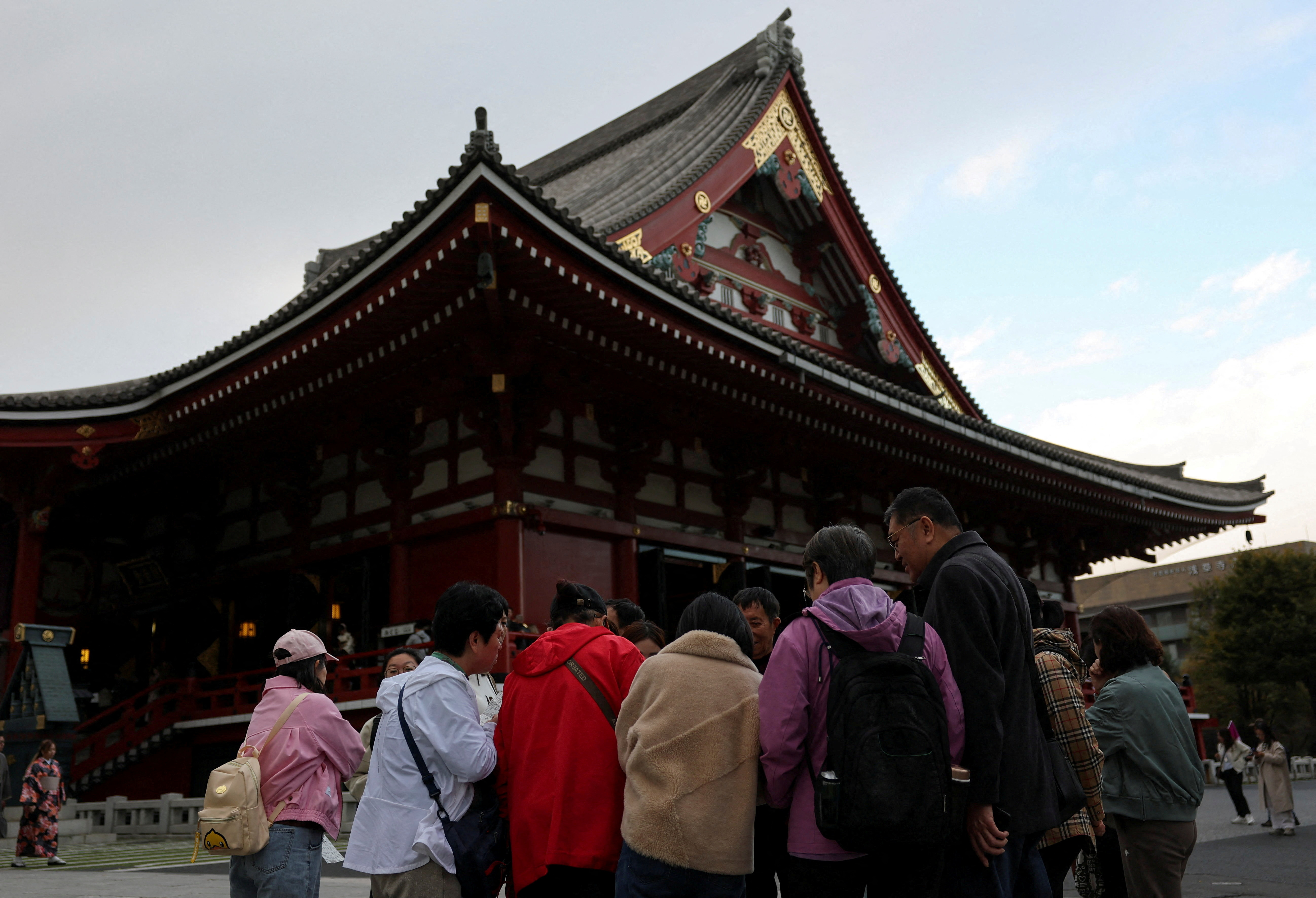 FILE PHOTO: A Chinese tourist group stands near the Sensoji temple, a popular sightseeing spot at the Asakusa district in Tokyo