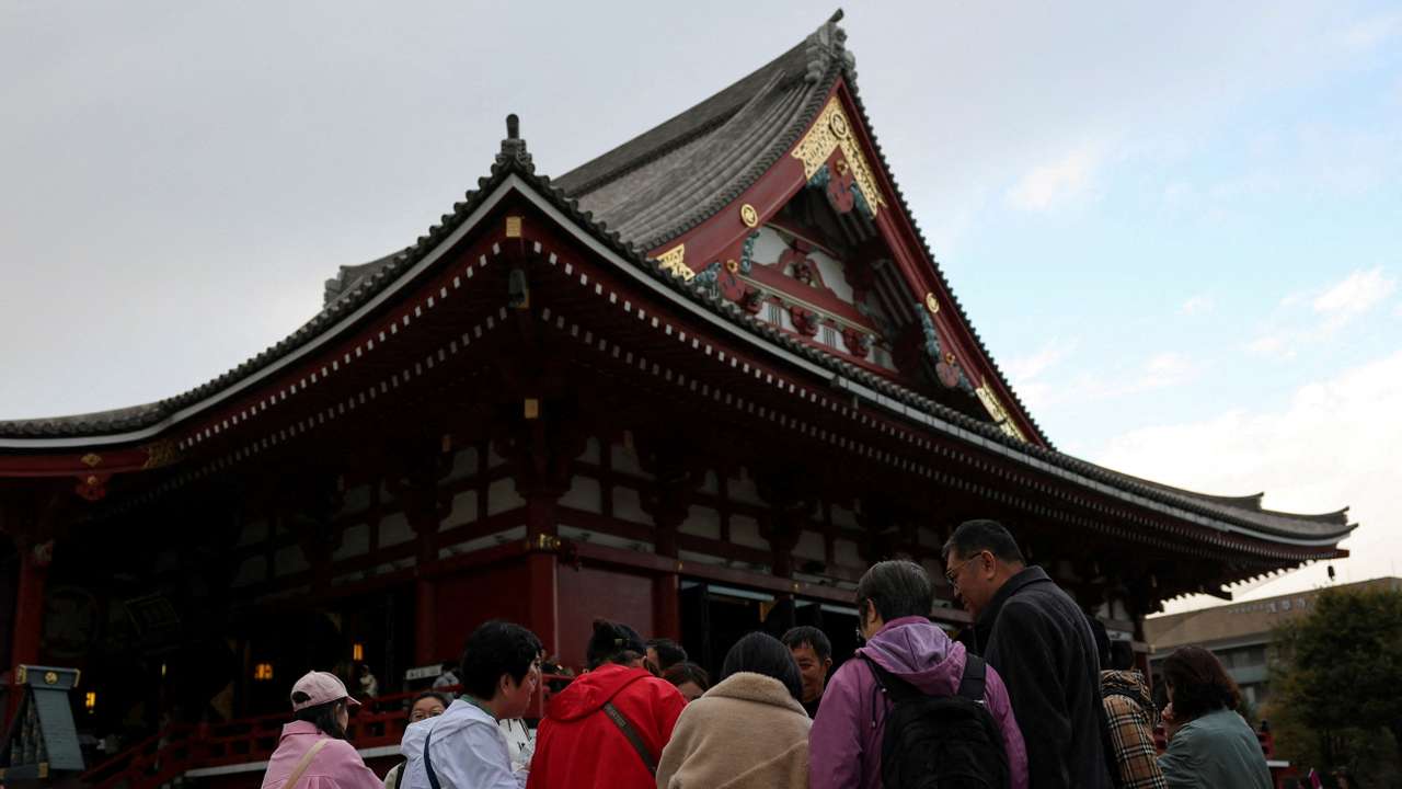 FILE PHOTO: A Chinese tourist group stands near the Sensoji temple, a popular sightseeing spot at the Asakusa district in Tokyo