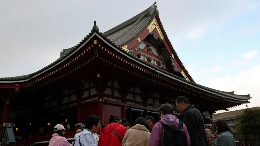 FILE PHOTO: A Chinese tourist group stands near the Sensoji temple, a popular sightseeing spot at the Asakusa district in Tokyo