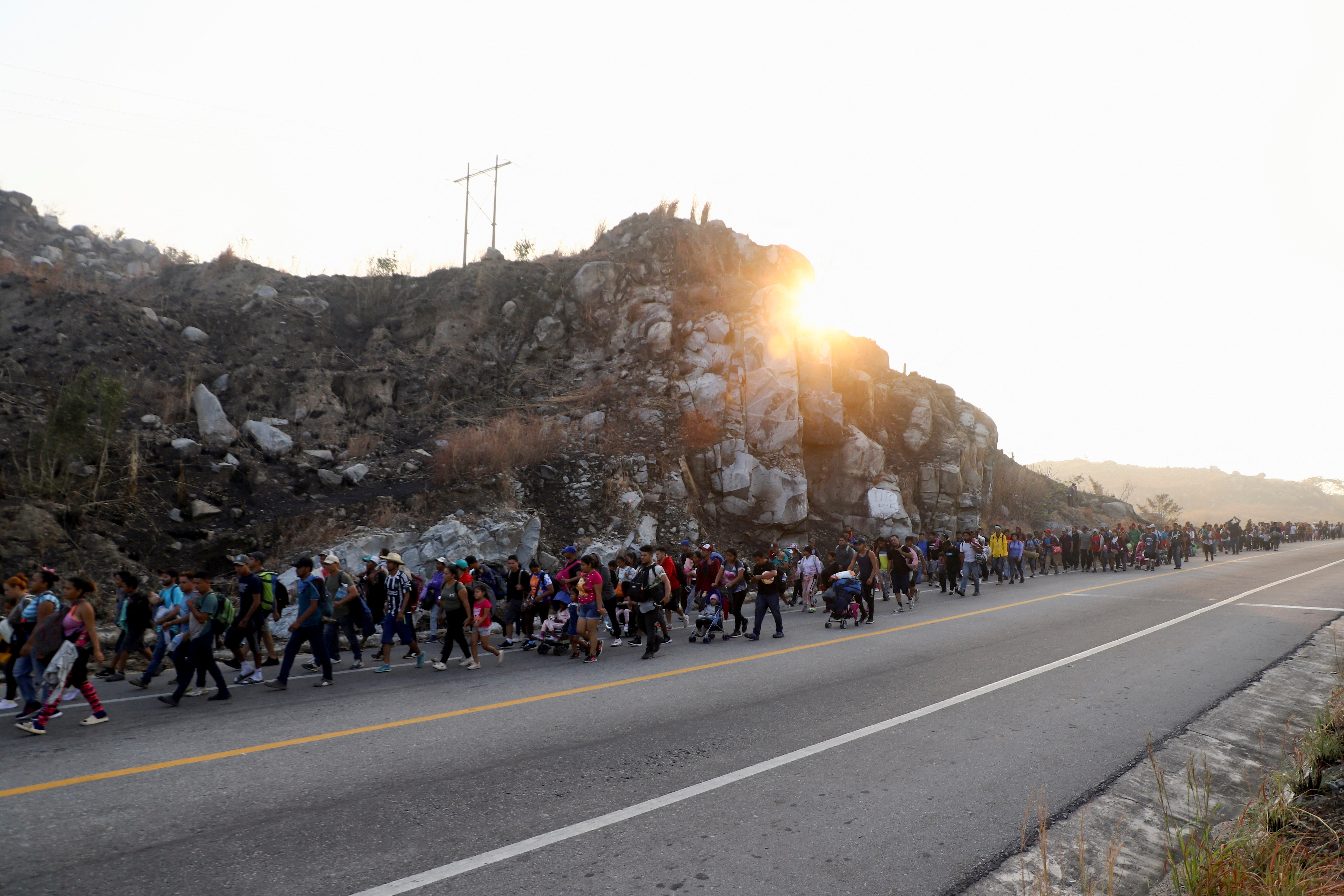 Migrants walk in a caravan as an attempt to reach the U.S. border, in Arriaga