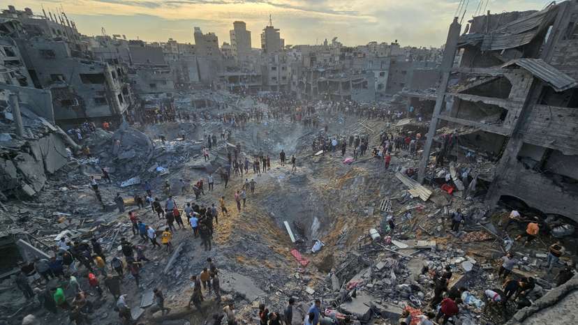 Palestinians search for casualties at the site of Israeli strikes on houses in Jabalia refugee camp