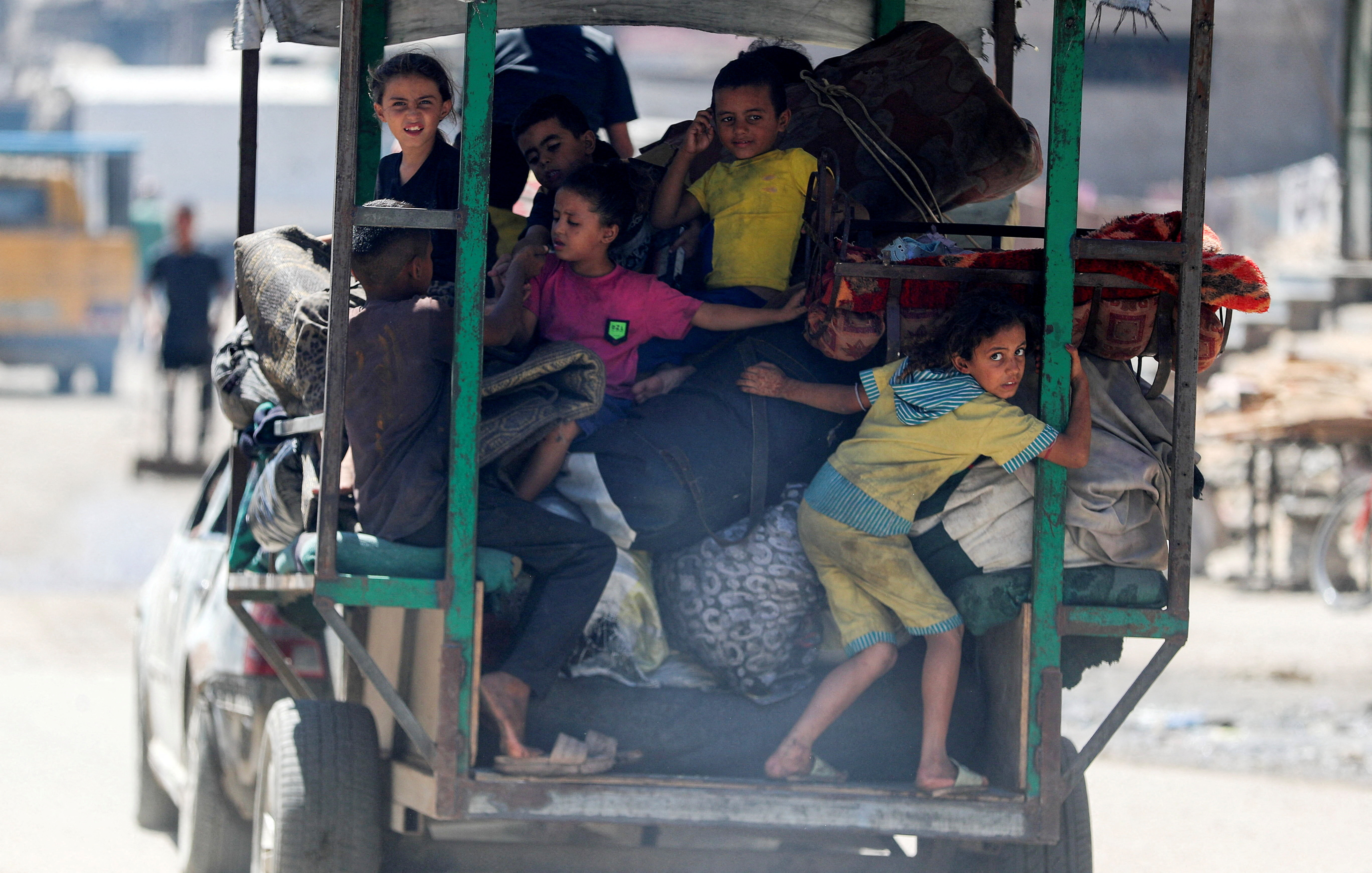 FILE PHOTO: Displaced Palestinians make their way as they flee amid an Israeli military operation, in Gaza City