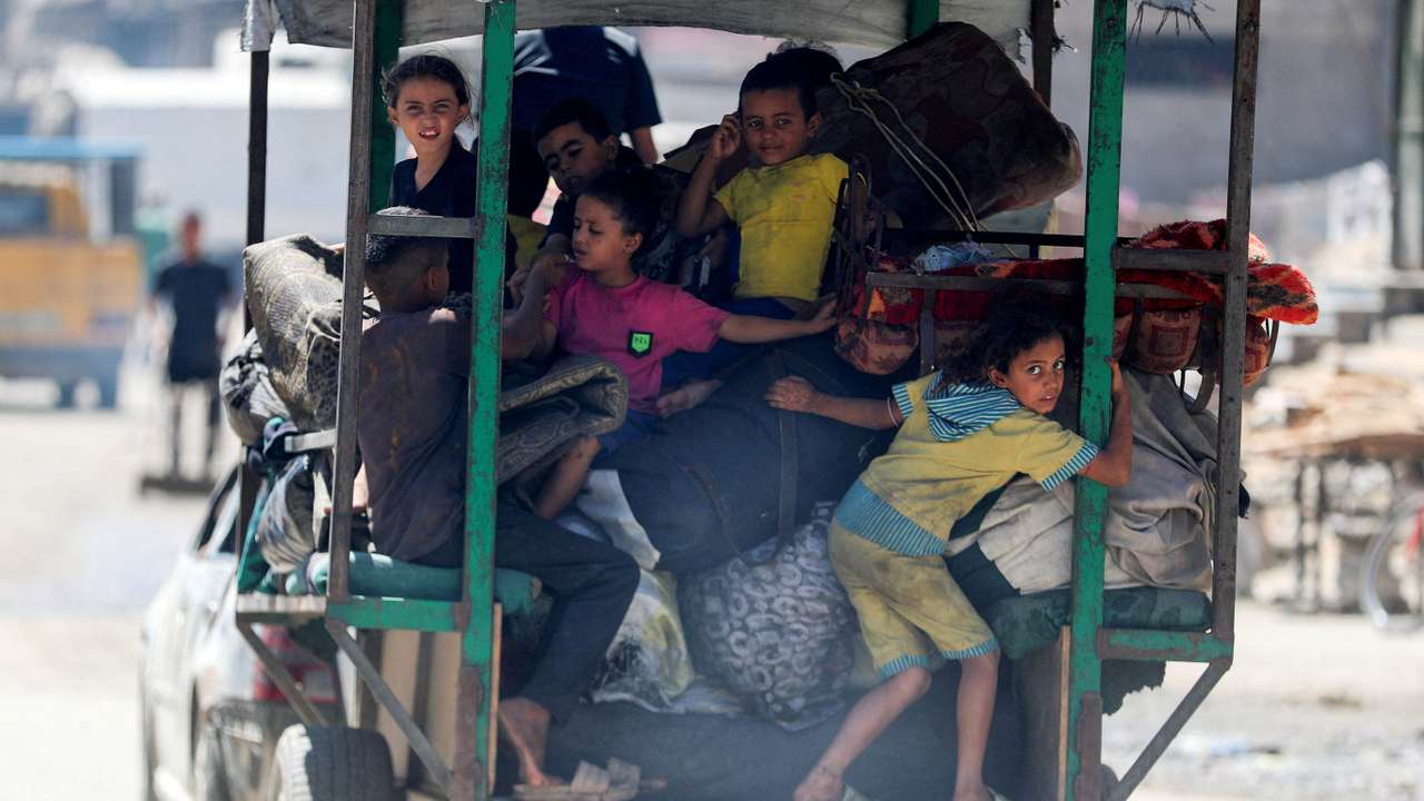 FILE PHOTO: Displaced Palestinians make their way as they flee amid an Israeli military operation, in Gaza City