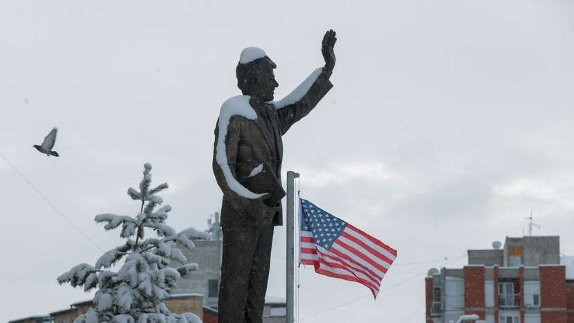 A statue of former U.S. President Bill Clinton is covered by snow, in Pristina