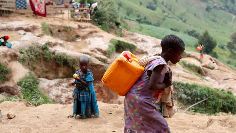 FILE PHOTO: A girl carries a container of water at a coltan mine in Kamatare, Masisi territory, North Kivu Province of Democratic Republic of Congo