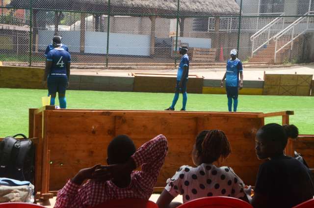 people watch blind football players compete during a match