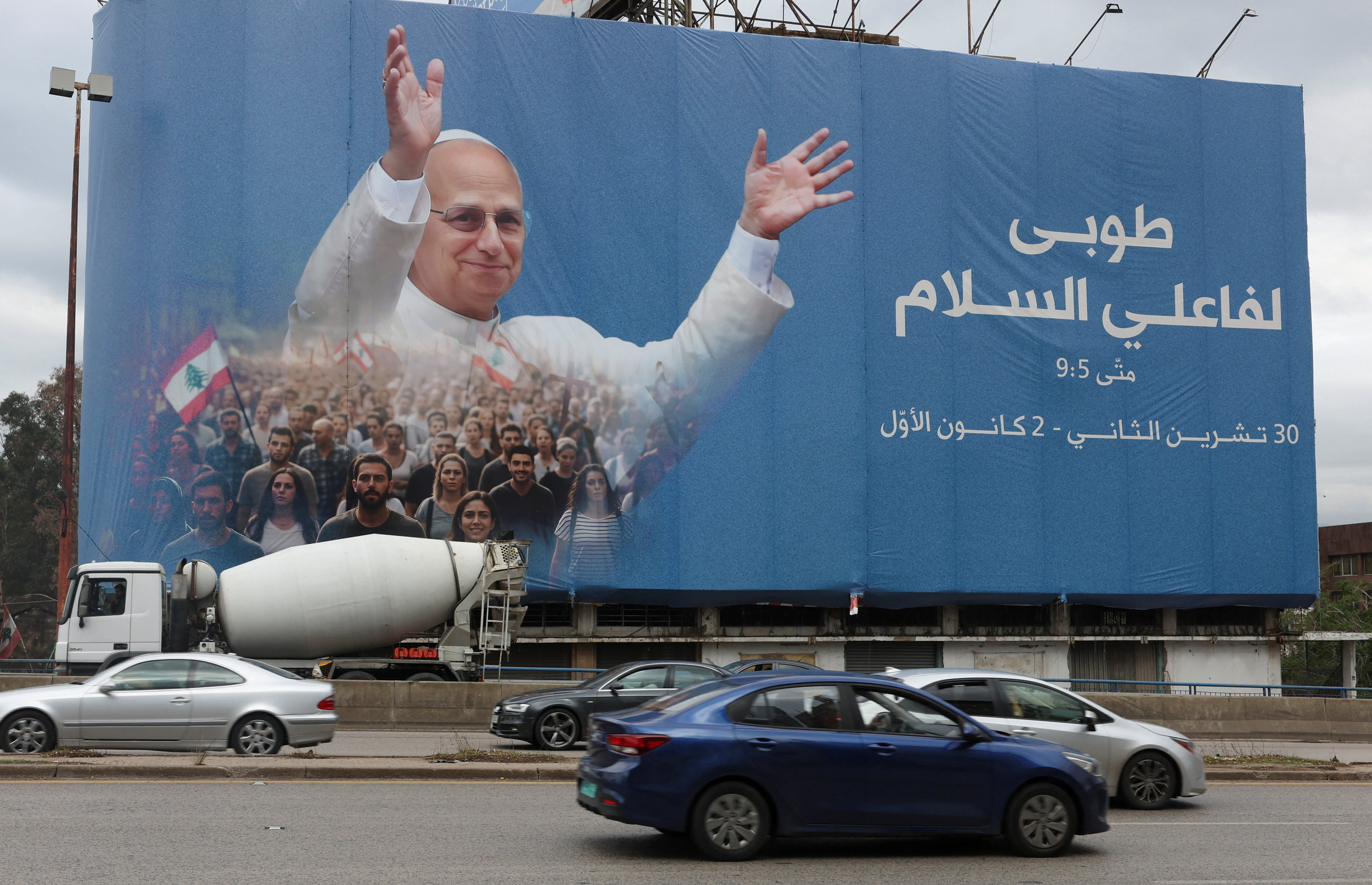 Cars drive past a billboard depicting Pope Leo XIV, ahead of his planned visit to Lebanon, in Beirut